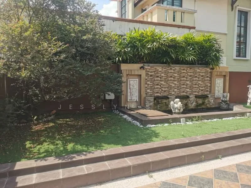 Exterior type: landscape garden; features: decorative stone wall, water feature with fountain, manicured lawn, tropical landscaping, mature trees, white gravel pathway, paved stone walkway, greenery surrounding the area; style: modern.