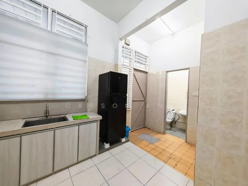 Kitchen features: single-bowl stainless-steel sink, black fridge, light wood cabinetry, grey countertop, white tiled backsplash, white walls, tile flooring, window with blinds, door leading to bathroom, green dish drying mat; style: modern. Bathroom features: toilet, white tiled walls, orange tiled flooring, door leading to kitchen.