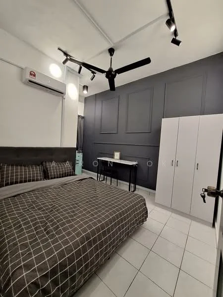 Bedroom features: king-size bed with grey checkered bedding, 2 bedside pillows, 1 wall-mounted split AC, 5-blade ceiling fan with light, grey accent wall with paneling, white tiled flooring, black study table, white wardrobe, curtains, decorative wall art; style: modern.