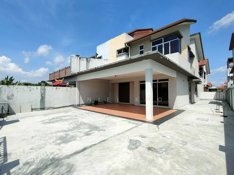 Exterior type: semi-detached house; features: two-storey building, concrete facade, flat roof, large outdoor patio area, manicured lawn, surrounding wall, driveway, windows with glass panes, outdoor space with tiles, clear blue sky, sunlight casting shadows; style: modern.