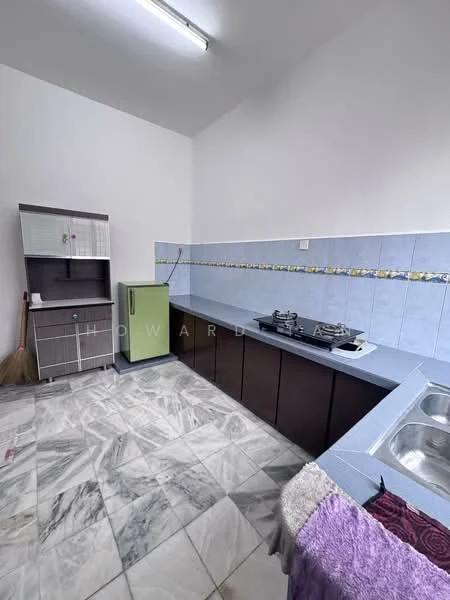 Kitchen features: grey laminate countertop, double-bowl stainless-steel sink, green fridge, freestanding gas stove with two burners, blue tiled backsplash, dark wood cabinetry, marble tile flooring, broom in corner.