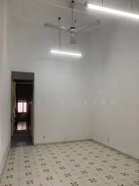 Room features: white painted walls, tile flooring with floral pattern, ceiling fan, two fluorescent ceiling lights, doorway leading to another room.