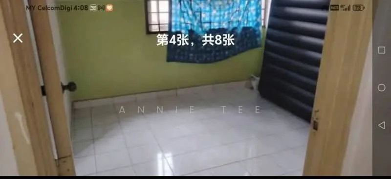 Room features: green painted walls, white tiled flooring, window with blue curtains, inflatable mattress, light from window, door with wooden frame.