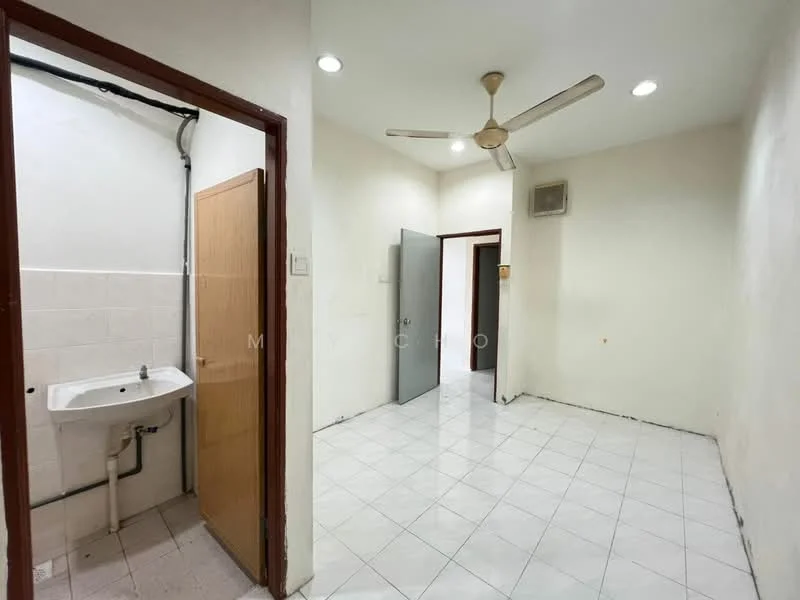 Room features: white painted walls, white tiled flooring, ceiling fan, recessed downlights, single-basin sink, door leading to another room, door leading to bathroom, corner wall with plumbing, empty space, no visible furniture.