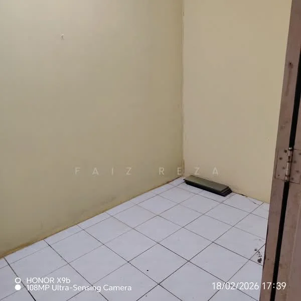 Room features: yellow painted walls, white tiled flooring, corner space, single window, no visible furniture, empty room.