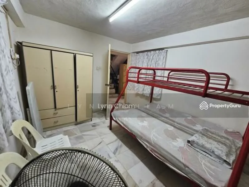 Bedroom features: bunk bed with red metal frame, mattress on top and bottom bunk, cream painted walls, marble flooring, built-in wardrobe with sliding doors, ceiling light fixture, window with sheer curtains, fan, plastic chairs.