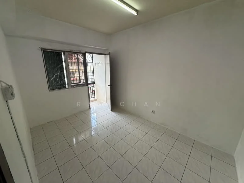 Room features: white painted walls, glossy ceramic tile flooring, single window with metal grille, door leading outside, fluorescent ceiling light.