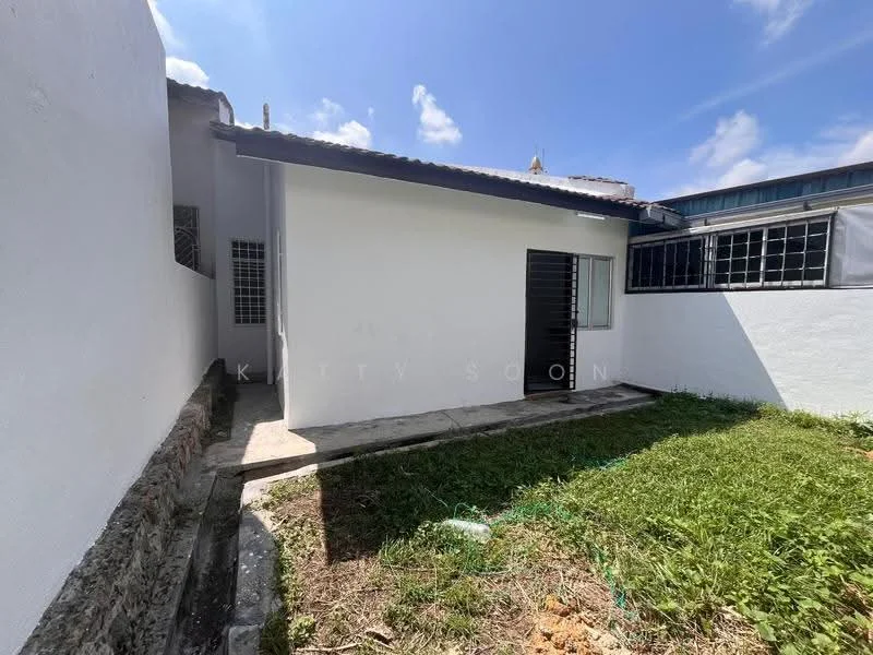 Exterior features: white painted facade, single-storey structure, concrete pathway, grass lawn, surrounding walls, metal gate, windows with grilles, roof with overhang; style: modern.