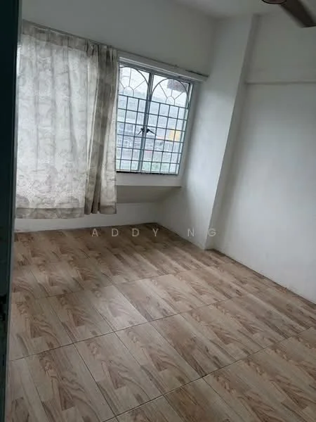 Room features: white painted walls, wooden flooring, large window with grid pattern, curtains, natural light, corner room, no visible furniture.