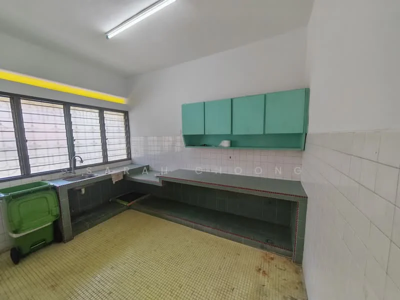 Kitchen features: green cabinetry, double-bowl stainless-steel sink, chrome faucet, white tiled walls, yellow tiled flooring, large windows with metal grilles, countertop with green tiles, built-in countertop space, open shelving, garbage bin.