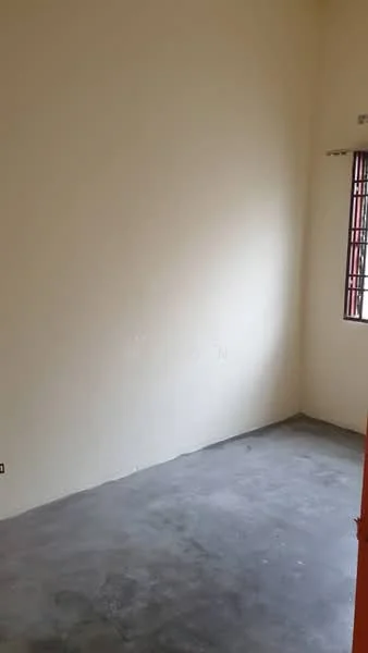 Room features: plain white walls, concrete flooring, single window with metal grille, no visible furniture or fixtures; style: minimalist.