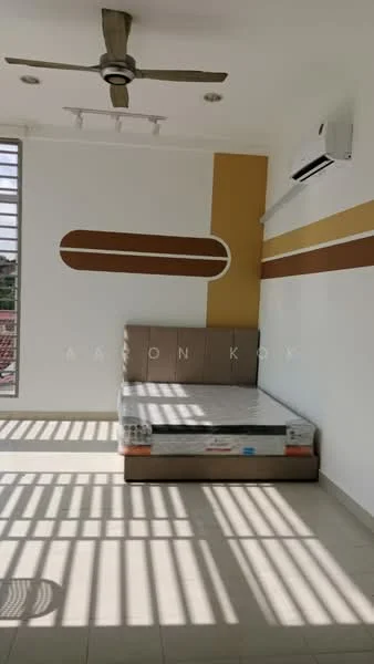 Bedroom features: queen-size bed frame, white painted walls, accent wall in mustard yellow, ceiling fan, wall-mounted split AC, large windows with horizontal bars, tile flooring, natural light casting shadows; style: modern.