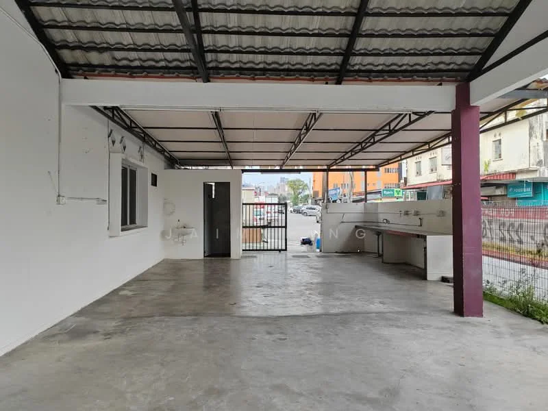 Exterior features: covered outdoor area, concrete flooring, white painted walls, metal roof, security gate, outdoor sink, open layout, surrounded by commercial buildings; style: modern.