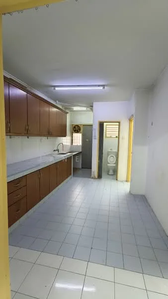 Kitchen features: brown wooden cabinetry, white marble countertop, single-bowl stainless-steel sink, chrome pull-down faucet, built-in oven, ceramic tile flooring, recessed ceiling lights, wall-mounted cabinets, open layout, doorway to bathroom, window for natural light; style: modern. Room features: toilet, white tiled walls, ceramic tile flooring.