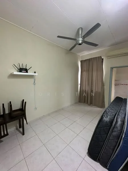 Room features: white painted walls, tile flooring, 5-blade ceiling fan, curtains, wall-mounted shelf, small dining table with two chairs, air conditioning unit, mattresses on the floor.