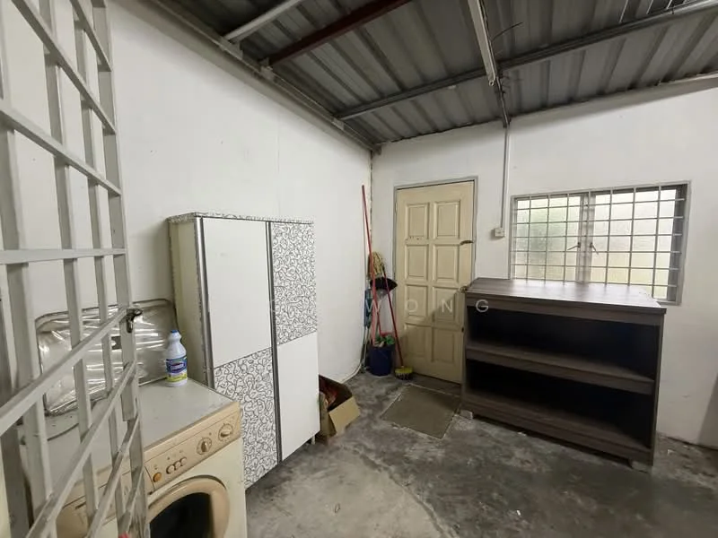 Laundry features: white cabinet with patterned design, wooden shelving unit, washing machine, concrete flooring, white painted walls, metal roof, single door, small window, cleaning supplies visible.