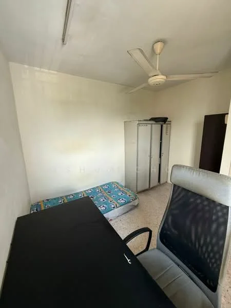 Room features: single bed mattress on the floor, office chair, desk, built-in wardrobe, ceiling fan, plain white walls, tile flooring, natural light from window.