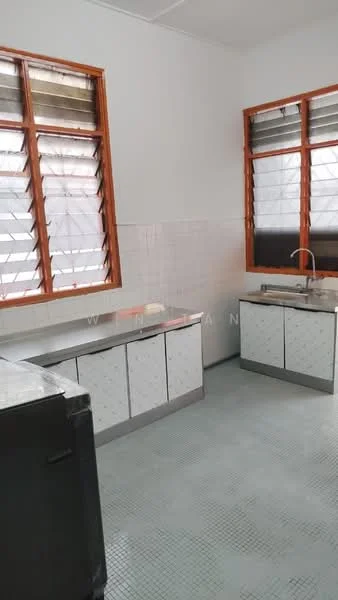 Kitchen features: white tiled walls, grey tiled flooring, stainless-steel sink, chrome faucet, kitchen cabinetry with white doors, countertop with grey surface, two large windows with wooden frames, window treatments with horizontal slats.