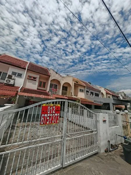Exterior type: linked terrace house; features: red tiled roof, white painted facade, metal gate, front yard with concrete pavement, air conditioning units visible, balcony on the upper floor, two-storey structure, surrounded by clear blue sky with clouds; style: modern.