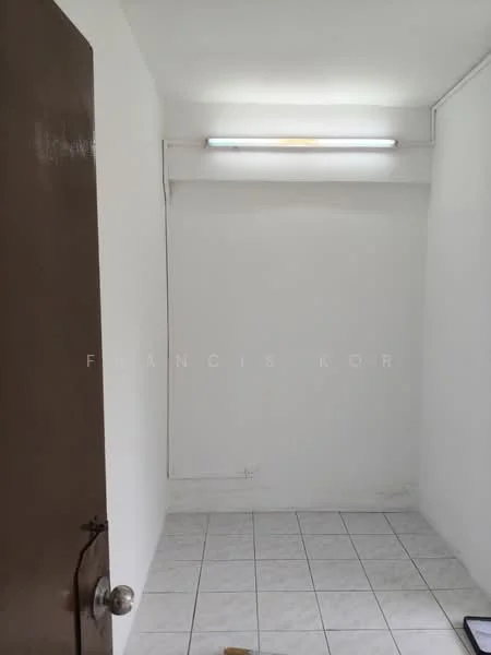 Room features: white painted walls, fluorescent ceiling light, white tiled flooring, door with metal handle.