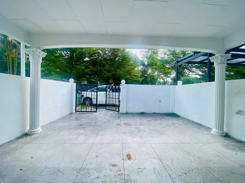 Exterior features: white painted walls, columns with decorative capitals, concrete flooring, gated entrance, landscaped greenery visible in background, outdoor lighting fixtures, open space, fenced perimeter; style: modern.