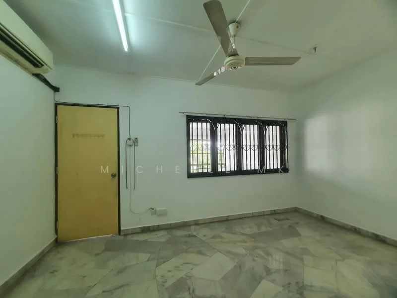 Room features: marble flooring, white painted walls, ceiling fan, window with black metal grilles, wall-mounted air conditioning unit, single wooden door, light fixture, corner wall outlet.