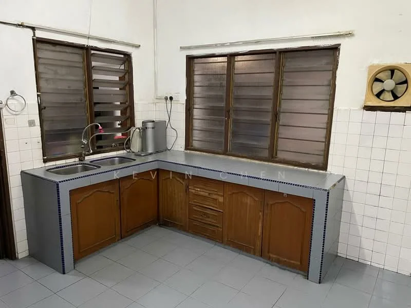 Kitchen features: L-shaped countertop, grey laminate countertop, wood cabinetry with brown finish, double-bowl stainless-steel sink, chrome pull-down faucet, window with horizontal slats, wall-mounted exhaust fan, white tiled backsplash, grey floor tiles, built-in storage drawers, open shelving above countertop.