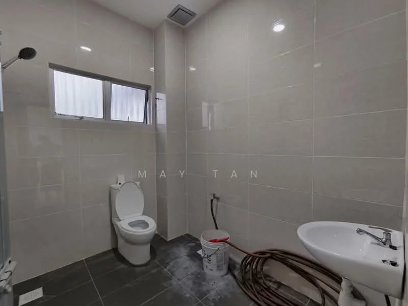 Bathroom features: white toilet, white pedestal sink, chrome faucet, glass shower enclosure, grey wall tiles, black floor tiles, window for natural light, plumbing exposed, bucket on the floor; style: modern.