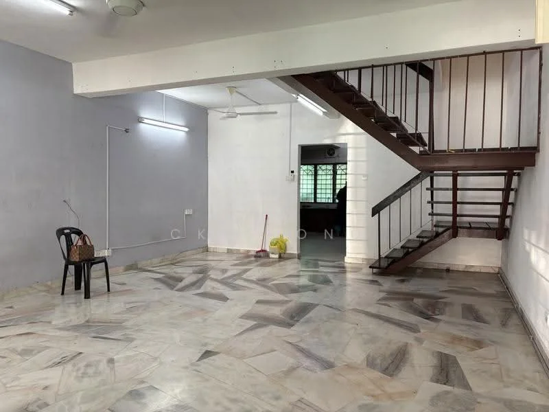 Room features: marble flooring, grey painted walls, white painted walls, staircase with wooden railing, ceiling lights, single black chair, cleaning broom, yellow bucket; style: minimalist.