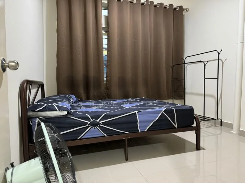 Bedroom features: single bed with blue and white geometric patterned bedding, brown curtains, white painted walls, glossy tile flooring, metal clothing rack, ceiling fan, window with natural light.