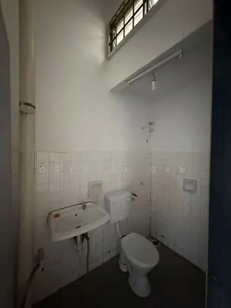 Bathroom features: white tiled walls, grey floor tiles, single-sink vanity, toilet, shower head, ceiling light fixture, window for natural light, wall-mounted mirror.