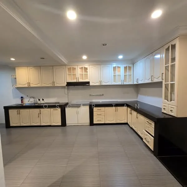Kitchen features: L-shaped kitchen layout, cream cabinetry with glass-front upper cabinets, black countertop, built-in oven, stainless-steel sink, chrome pull-down faucet, ceramic tile flooring, recessed LED downlights, white painted walls, ventilation hood, multiple storage drawers, kitchen island with storage; style: modern.