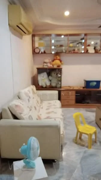 Living features: 3-seater fabric sofa with floral pattern, marble flooring, wall-mounted split AC, wooden shelving unit, decorative items on shelves, small yellow plastic chair, table with fan, soft toys on shelves, ceiling lights.