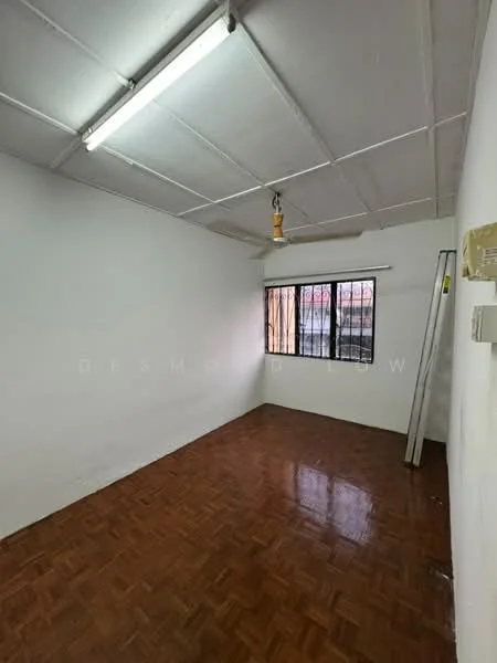 Room features: white painted walls, parquet wood flooring, ceiling with fluorescent lighting, window with metal bars, single window, no visible furniture, empty space, light switch on the wall.