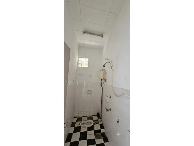 Bathroom features: white tiled walls, black and white checkered flooring, shower head, toilet, wall-mounted water heater, sink with faucet, small window for natural light, ceiling with visible panels.