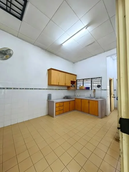 Kitchen features: wooden cabinetry with orange finish, grey countertop, single-bowl stainless-steel sink, chrome faucet, white tiled backsplash, white tiled walls, cream tiled flooring, ceiling fan, window with metal grille, built-in storage cabinets.