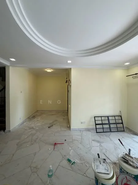 Room features: white painted walls, marble flooring, recessed downlights, crown moulding, unfinished space with construction materials, paint buckets, cleaning tools, staircase visible in background.