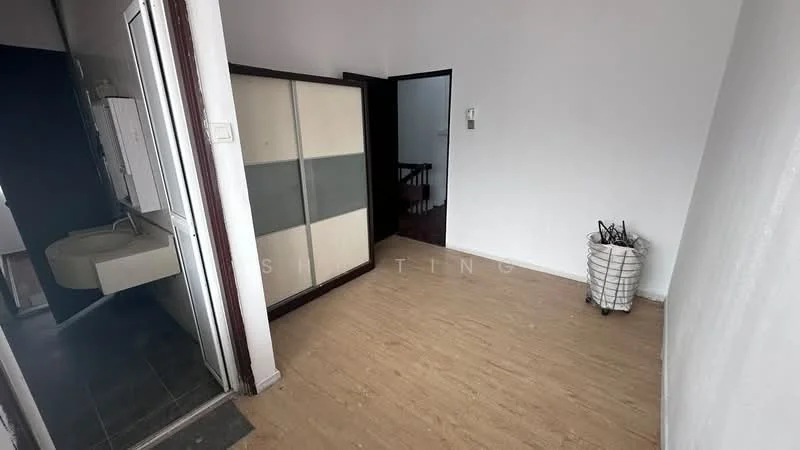 Room features: light wood laminate flooring, white painted walls, doorway leading to another room, partition with frosted glass panels, visible plumbing fixtures, staircase visible in the background, basket or storage container.