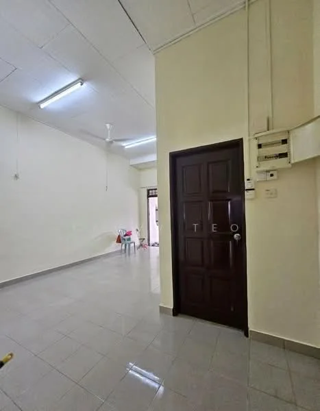 Room features: white painted walls, grey tiled flooring, ceiling with fluorescent lighting, 1 ceiling fan, wooden door, door handle, electrical switchboard, open space layout; style: minimalist.