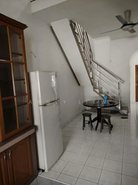 Room features: white painted walls, ceramic tile flooring, stainless-steel fridge, wooden cabinetry with glass doors, round dining table, two wooden stools, ceiling fan, staircase with metal railing; style: modern.