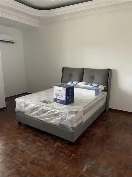 Bedroom features: king-size bed with upholstered headboard, mattress wrapped in plastic, wooden parquet flooring, white painted walls, crown moulding, wall-mounted split AC; style: modern.