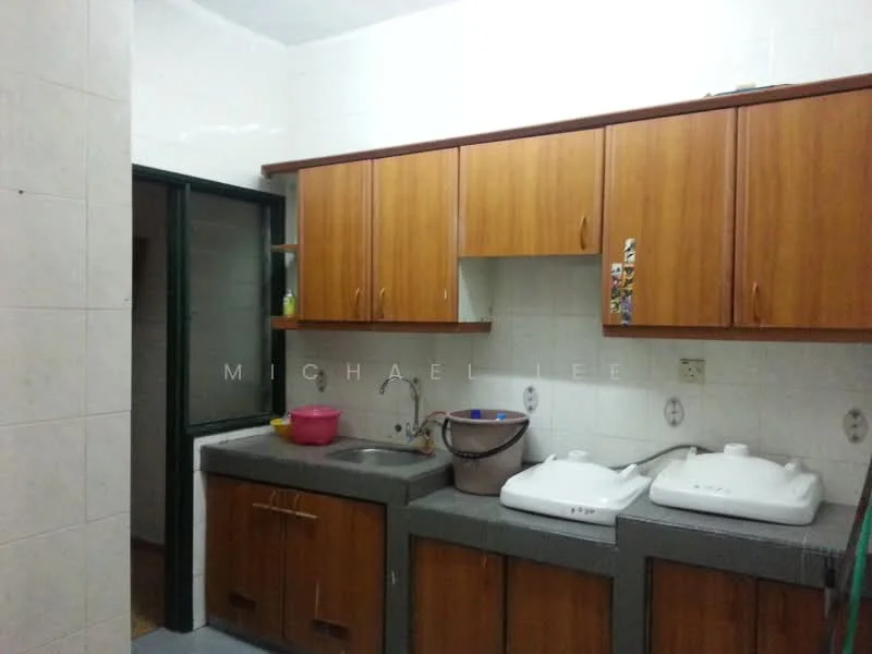 Kitchen features: wooden cabinetry, grey countertop, single-bowl stainless-steel sink, wall-mounted faucet, two built-in washing basins, white tiled walls, ceramic tile flooring, window with green frame, pink plastic basin.
