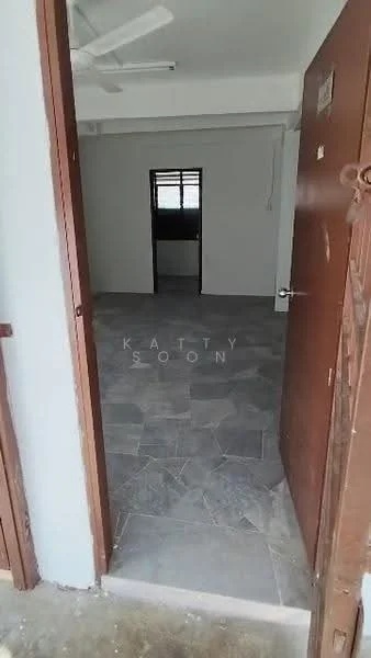 Room features: grey stone flooring, plain white walls, ceiling fan, window with grid, door with metal handle, open layout, no visible furniture, natural light from window; style: minimalist.