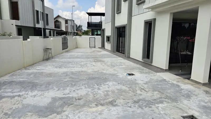 Exterior type: detached bungalow; features: concrete flooring, white painted walls, fenced perimeter, outdoor space, minimal landscaping, adjacent to building, open layout, partially shaded area; style: modern.