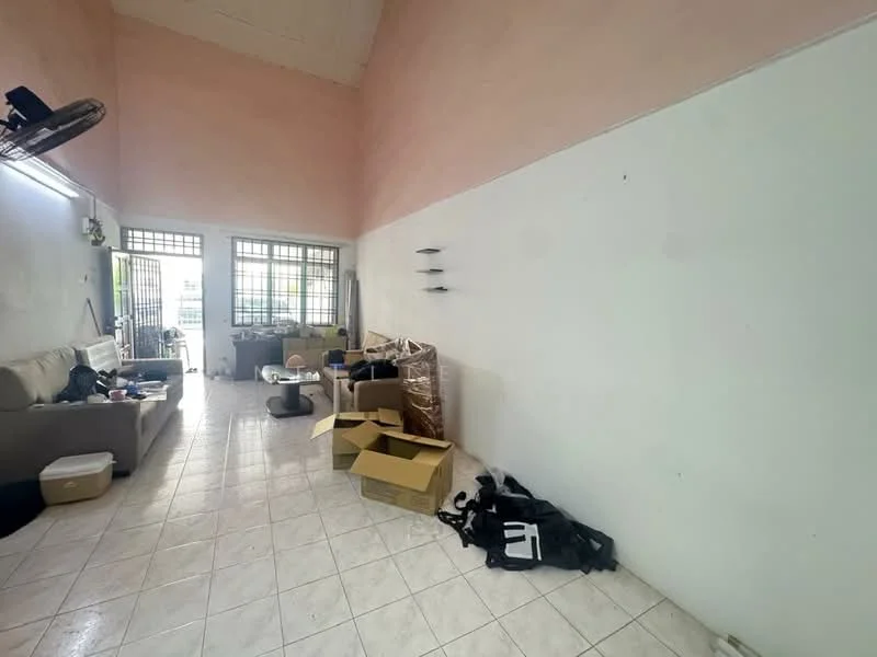 Living features: light pink painted walls, white tiled flooring, sofa, coffee table, boxes, various items on floor, window with grille, ceiling fan.