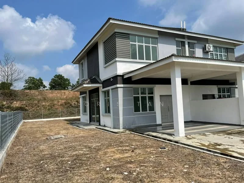 Exterior type: detached bungalow; features: two-storey building, grey painted facade, flat roof, large windows, covered porch, exposed concrete flooring, surrounded by open land, air conditioning unit visible, manicured lawn area, fenced perimeter, driveway, minimal landscaping; style: modern.