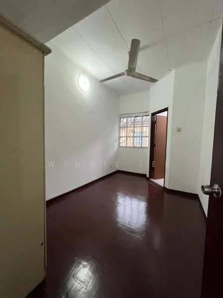 Room features: white painted walls, brown laminate flooring, ceiling fan, window with grid, door with handle, light fixture on ceiling.