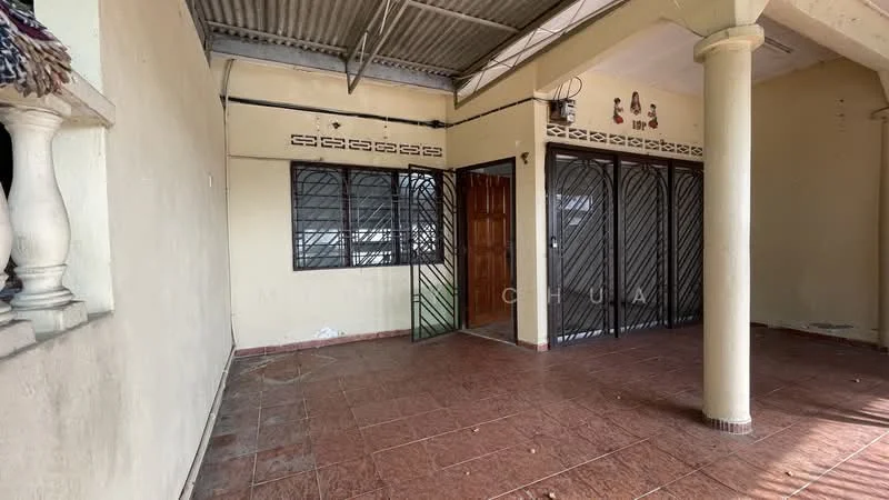 Room features: terracotta tile flooring, cream painted walls, metal security grilles on windows, wooden door, exposed ceiling beams, column support, open layout, no visible furniture.