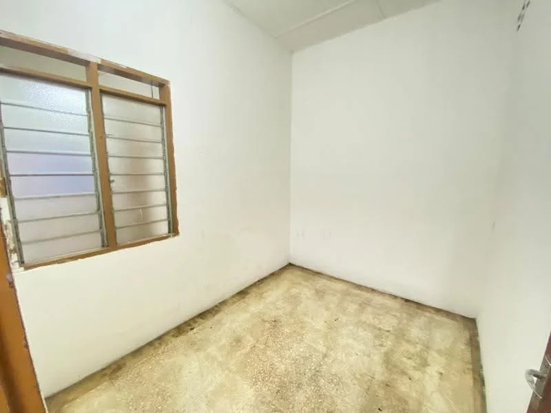 Room features: white painted walls, concrete flooring, single window with horizontal bars, no visible lighting fixtures, no visible furniture or decor; style: minimalist.