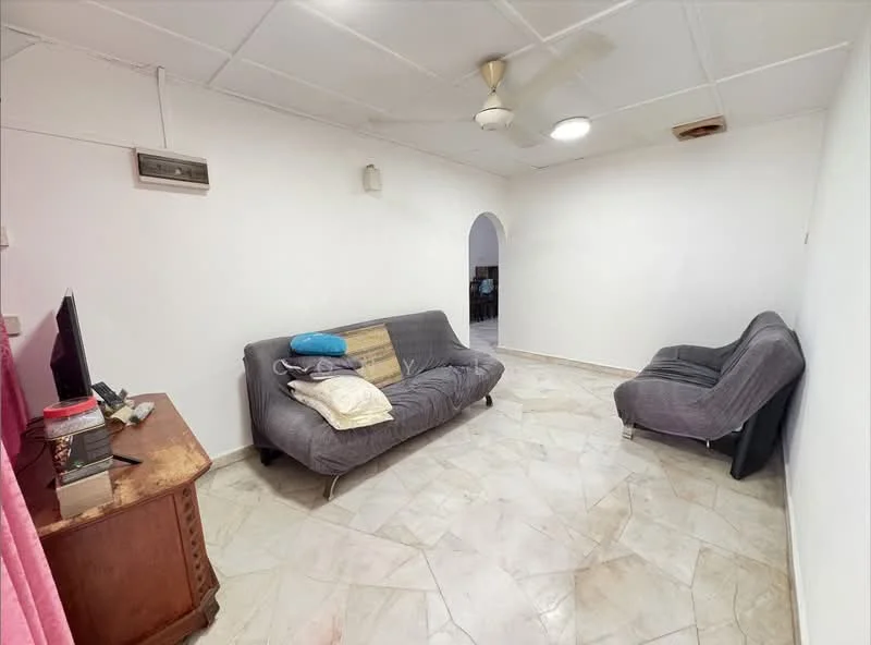 Living features: grey fabric sofa, single armchair in grey, wooden side table, ceiling fan, wall-mounted air conditioning unit, marble tile flooring, white painted walls, arched doorway leading to another room, decorative throw pillows.